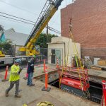 The Walker Brothers machinery moving team lifting power equipment out of an underground substation.