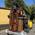 A Walker Brothers forklift moving old power equipment.